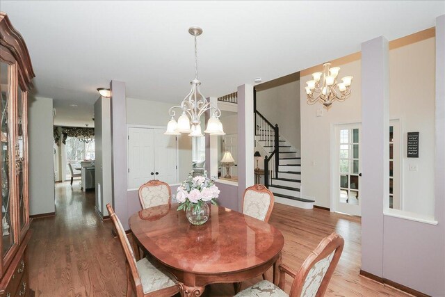 dining area featuring an inviting chandelier, wood finished floors, and a wealth of natural light