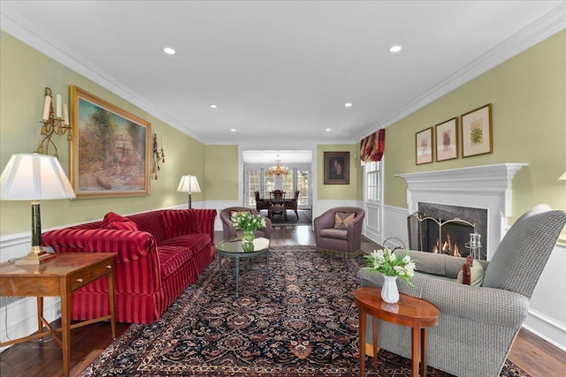 1300 Hackberry Ln, Winnetka, IL 60093 - living room featuring wood finished floors, a chandelier, wainscoting, recessed lighting, and a fireplace