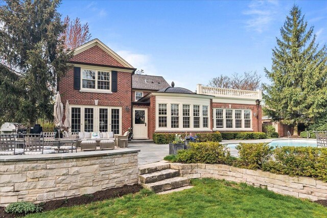 1300 Hackberry Ln, Winnetka, IL 60093 - back of house featuring a patio area, brick siding, outdoor lounge area, and an outdoor pool