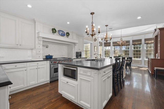 1300 Hackberry Ln, Winnetka, IL 60093 - kitchen featuring a chandelier, built in microwave, range with two ovens, dark countertops, and recessed lighting