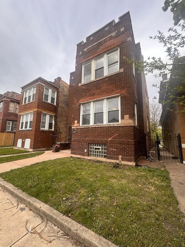 7646 S May St, Chicago, IL 60620 - front facade with a front lawn, brick siding, and fence