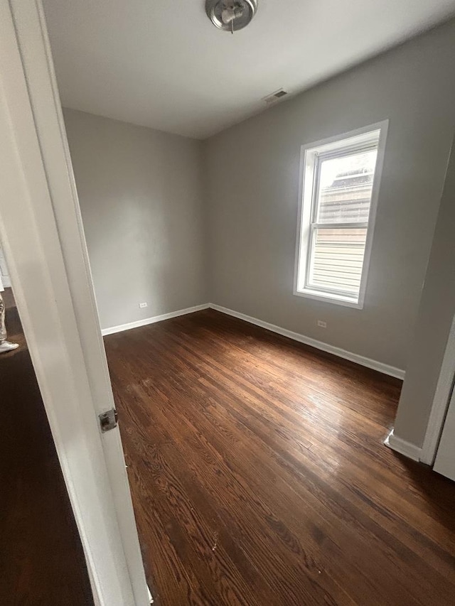 7646 S May St, Chicago, IL 60620 - empty room featuring baseboards and dark wood finished floors