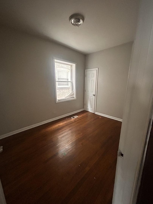 7646 S May St, Chicago, IL 60620 - spare room featuring visible vents, baseboards, and dark wood-style floors