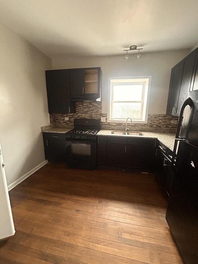 7646 S May St, Chicago, IL 60620 - kitchen featuring wood finished floors, tasteful backsplash, black appliances, and a sink
