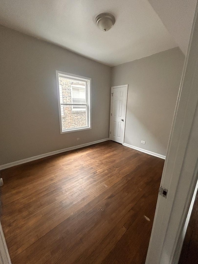 7646 S May St, Chicago, IL 60620 - empty room featuring dark wood finished floors and baseboards