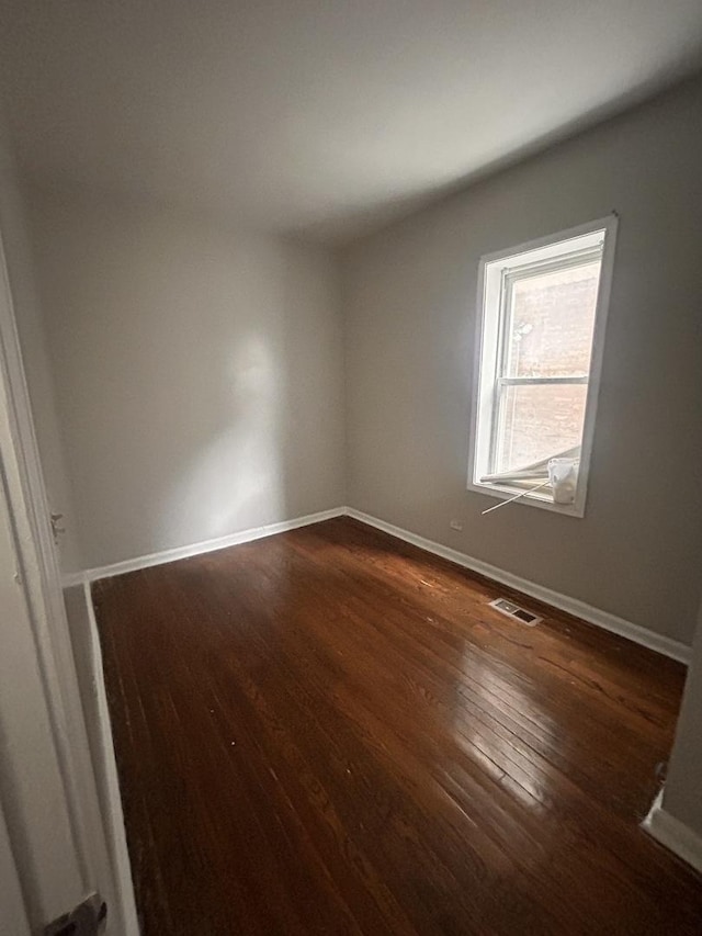 7646 S May St, Chicago, IL 60620 - unfurnished room featuring visible vents, baseboards, and dark wood-style floors