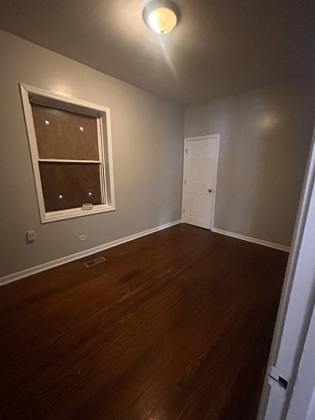 7646 S May St, Chicago, IL 60620 - empty room with baseboards, dark wood finished floors, and visible vents