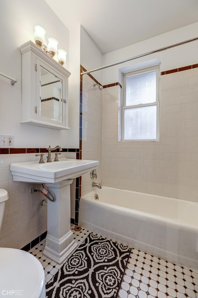 1949 W Argyle St Unit 1, Chicago, IL 60640 - bathroom with shower / washtub combination, tile walls, and a wainscoted wall