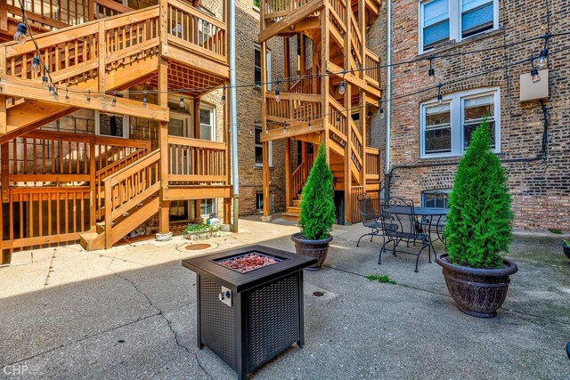 1949 W Argyle St Unit 1, Chicago, IL 60640 - view of patio / terrace featuring stairs, a fire pit, and outdoor dining area