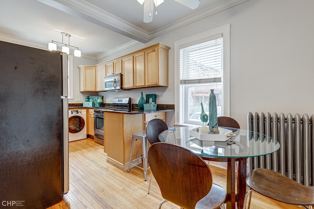 1949 W Argyle St Unit 1, Chicago, IL 60640 - kitchen featuring stainless steel appliances, radiator, washer / clothes dryer, light wood-style floors, and crown molding
