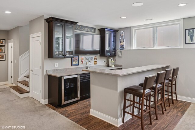 bar with dark wood-type flooring, stairway, recessed lighting, and wine cooler