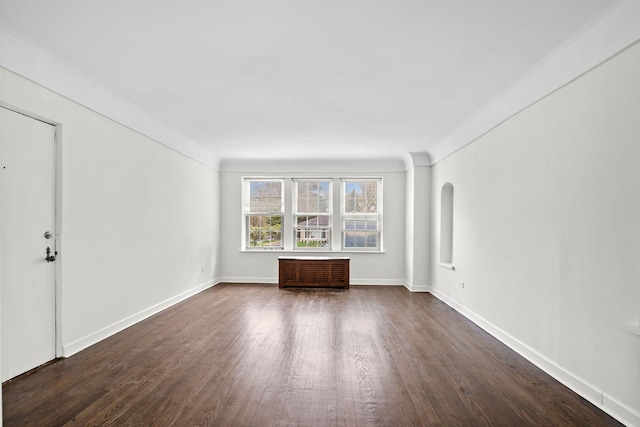 interior space featuring baseboards and dark wood-style floors