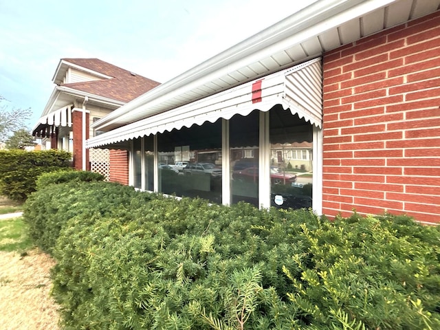 view of property exterior with brick siding
