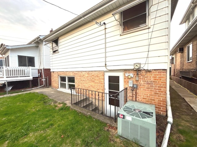 rear view of house featuring central air condition unit