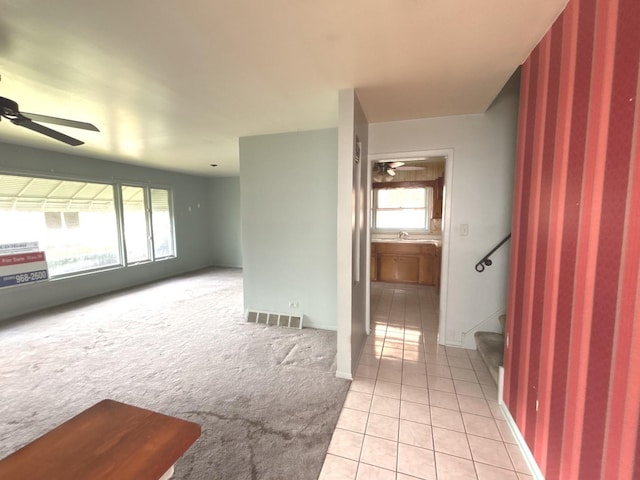 spare room featuring ceiling fan, light tile patterned flooring, wallpapered walls, stairs, and baseboards
