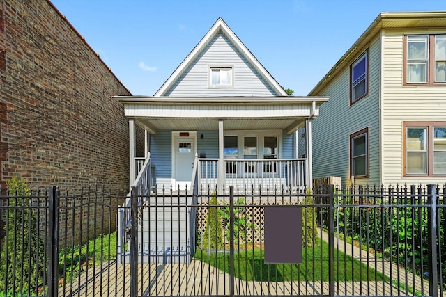 10617 S Wentworth Ave, Chicago, IL 60628 - view of front of house with a porch, a fenced front yard, and a gate