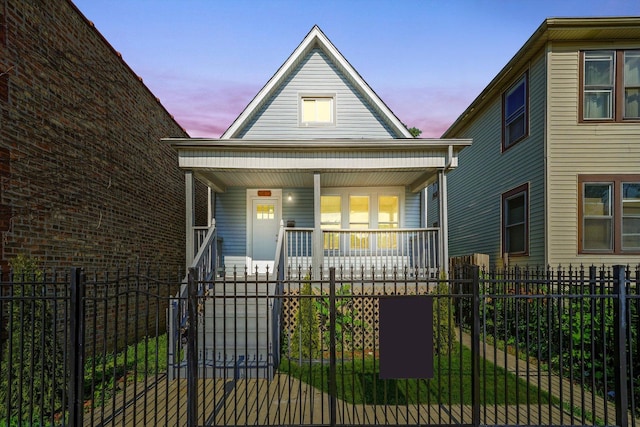 10617 S Wentworth Ave, Chicago, IL 60628 - bungalow-style house featuring covered porch, a fenced front yard, and a gate