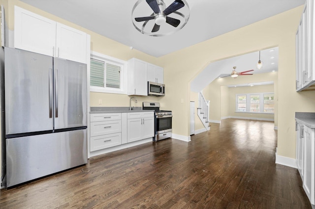 10617 S Wentworth Ave, Chicago, IL 60628 - kitchen featuring stainless steel appliances, a ceiling fan, dark wood-style flooring, white cabinets, and open floor plan