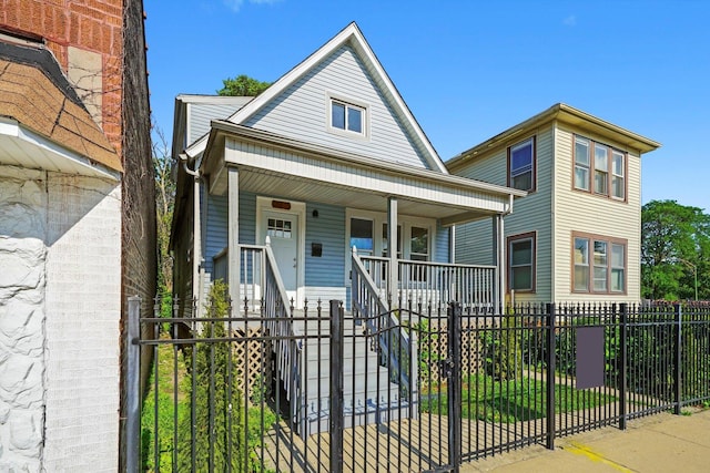 10617 S Wentworth Ave, Chicago, IL 60628 - view of front facade featuring a porch and a fenced front yard