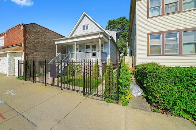 10617 S Wentworth Ave, Chicago, IL 60628 - view of front of home with covered porch, a fenced front yard, and a gate
