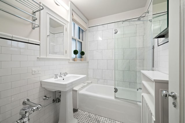 full bath featuring  shower combination, tile patterned floors, and tile walls