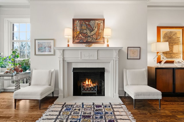 sitting room featuring crown molding, a fireplace, and wood finished floors