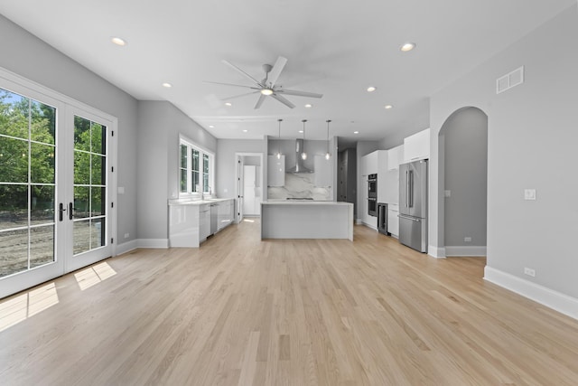 7213 Daybreak Ln, Long Grove, IL 60060 - unfurnished living room featuring a ceiling fan, arched walkways, recessed lighting, baseboards, and light wood-style flooring