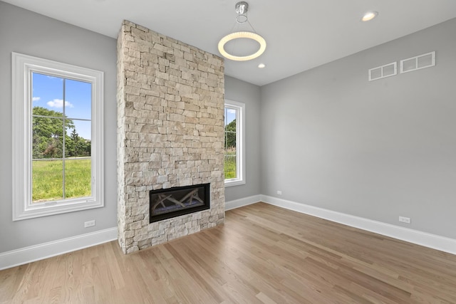 7213 Daybreak Ln, Long Grove, IL 60060 - unfurnished living room with baseboards, a stone fireplace, wood finished floors, and recessed lighting