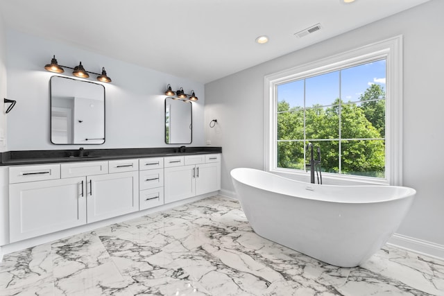7213 Daybreak Ln, Long Grove, IL 60060 - bathroom featuring double vanity, marble finish flooring, a freestanding tub, recessed lighting, and baseboards