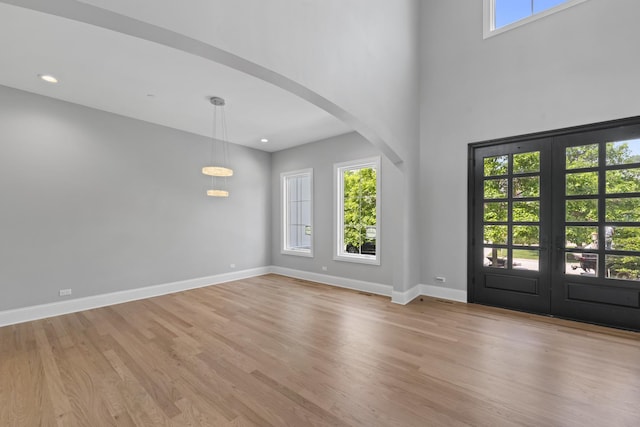 7213 Daybreak Ln, Long Grove, IL 60060 - foyer featuring arched walkways, healthy amount of natural light, light wood-style flooring, french doors, and a high ceiling