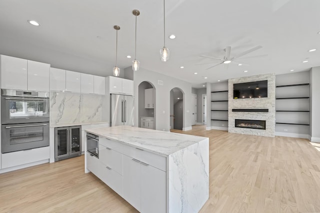 7213 Daybreak Ln, Long Grove, IL 60060 - kitchen featuring stainless steel appliances, beverage cooler, modern cabinets, white cabinets, and ceiling fan