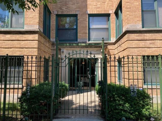7308 S Yates Blvd Unit 1, Chicago, IL 60649 - entrance to property with brick siding, a gate, and fence