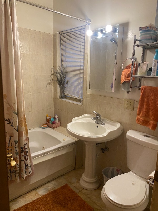 7308 S Yates Blvd Unit 1, Chicago, IL 60649 - full bath with shower / bath combo with shower curtain, a sink, toilet, and tile walls