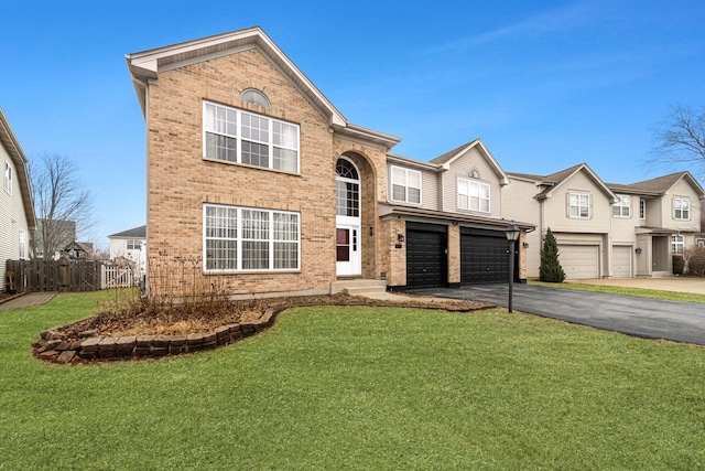 view of front facade featuring a garage, aphalt driveway, fence, a front yard, and brick siding