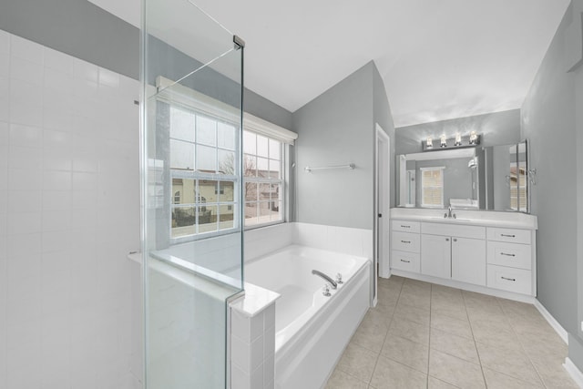 full bathroom featuring a bath, baseboards, tile patterned flooring, a shower stall, and vanity