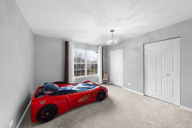 bedroom featuring baseboards, carpet flooring, and a chandelier