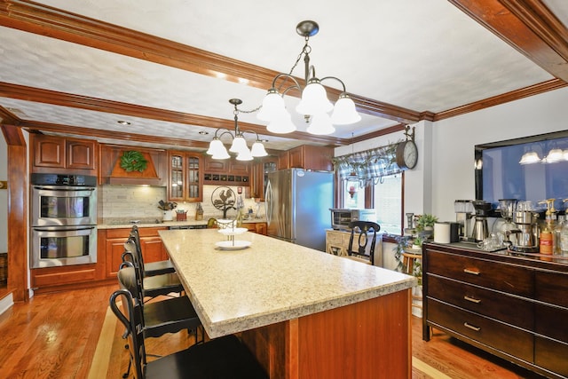 9201 175th St, Tinley Park, IL 60487 - kitchen with stainless steel appliances, a chandelier, tasteful backsplash, light wood-style floors, and ornamental molding