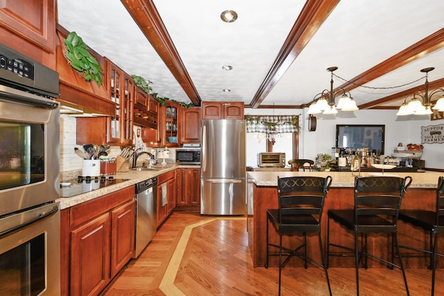 9201 175th St, Tinley Park, IL 60487 - kitchen featuring appliances with stainless steel finishes, beamed ceiling, a breakfast bar area, glass insert cabinets, and hanging light fixtures