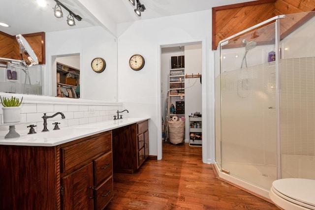 9201 175th St, Tinley Park, IL 60487 - bathroom with a walk in closet, wood finished floors, a shower stall, double vanity, and tasteful backsplash