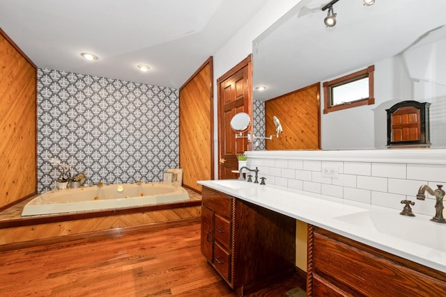9201 175th St, Tinley Park, IL 60487 - bathroom with double vanity, a tub with jets, backsplash, rail lighting, and wallpapered walls