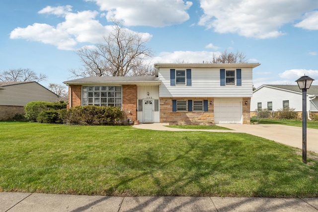 tri-level home featuring a garage, a front yard, driveway, and stone siding