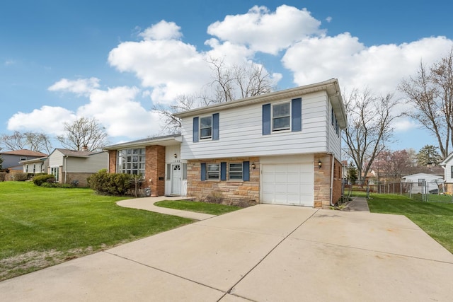 tri-level home with an attached garage, a front lawn, fence, and concrete driveway