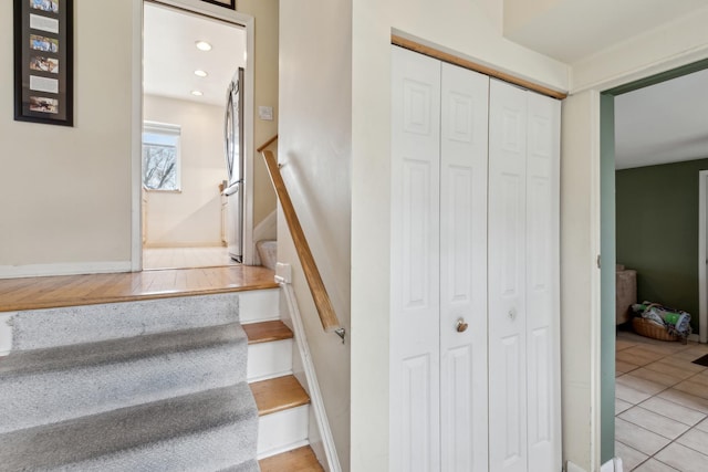 stairway with recessed lighting and tile patterned flooring