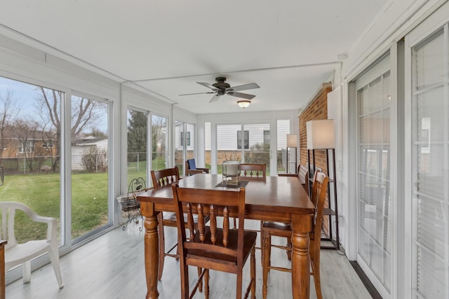 sunroom with plenty of natural light and wood finished floors