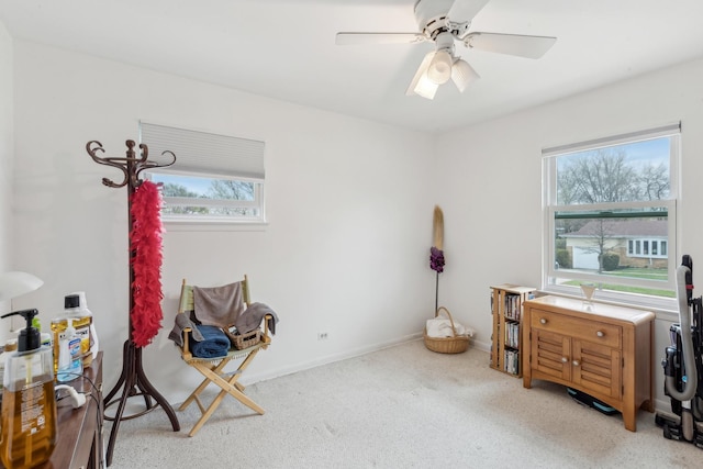 miscellaneous room featuring a ceiling fan, baseboards, plenty of natural light, and carpet