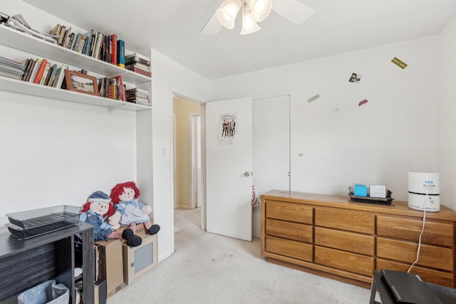 interior space featuring light colored carpet and ceiling fan