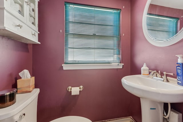 half bath with toilet and a sink