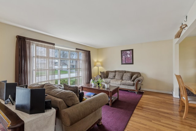 living room featuring light wood-type flooring and baseboards