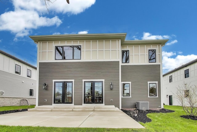 7302 Ponto Ct, Morton Grove, IL 60053 - rear view of house with central AC unit, a patio area, and a lawn