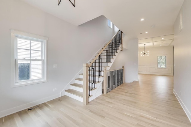 7302 Ponto Ct, Morton Grove, IL 60053 - stairs with wood finished floors, a chandelier, and recessed lighting